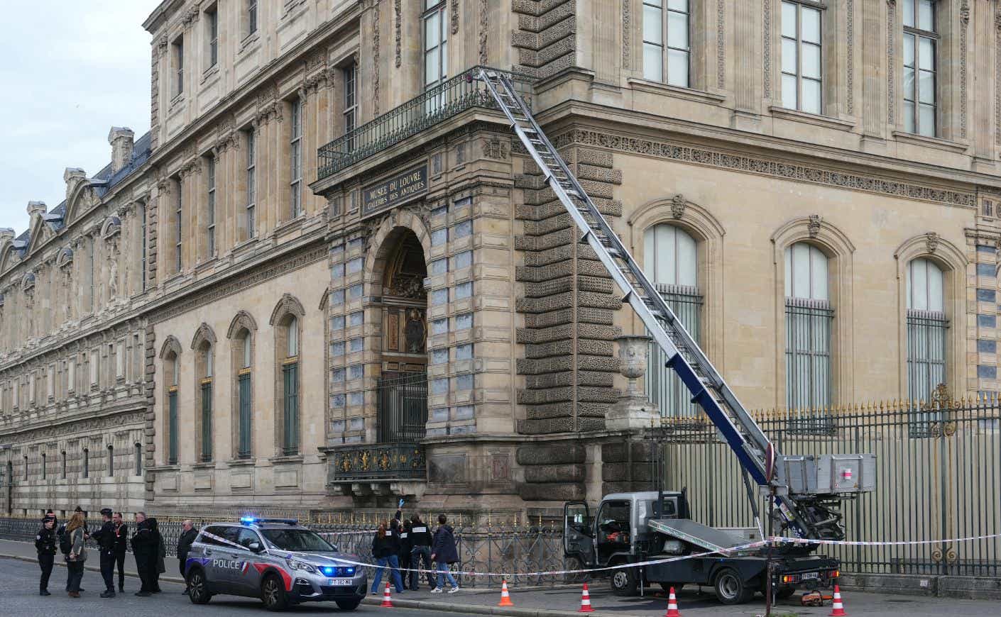 French police officers stand next to a furniture elevator used by thieves to enter the Louvre Museum. (Getty Images)