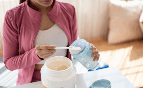 A woman making a protein shake
