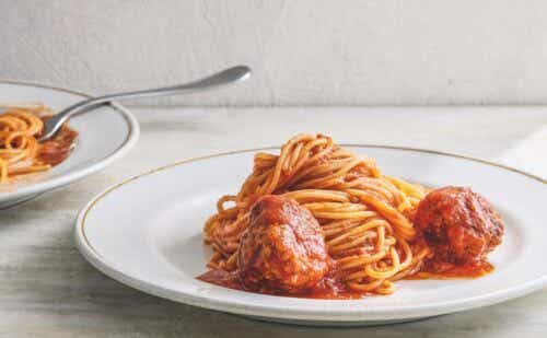 Two plates of spaghetti and meatballs.