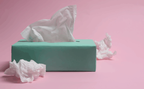 a tissue box next to used tissues