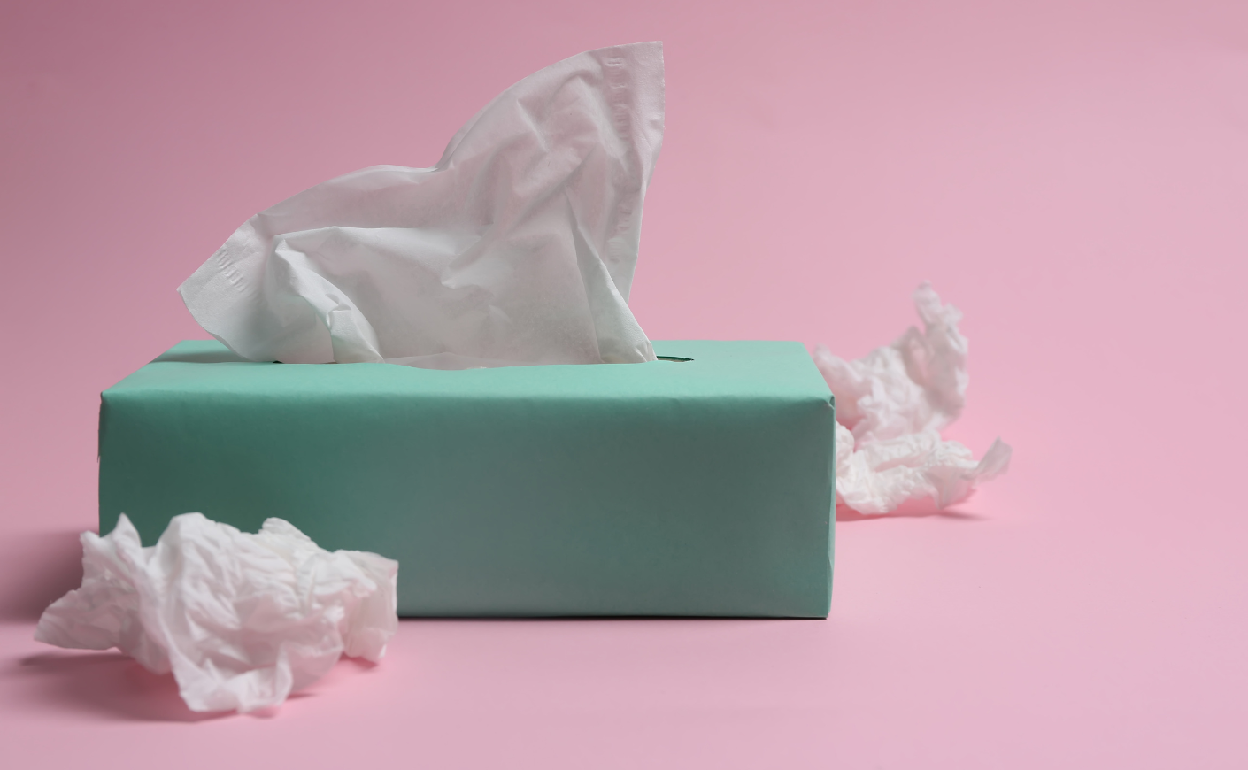 a tissue box next to used tissues