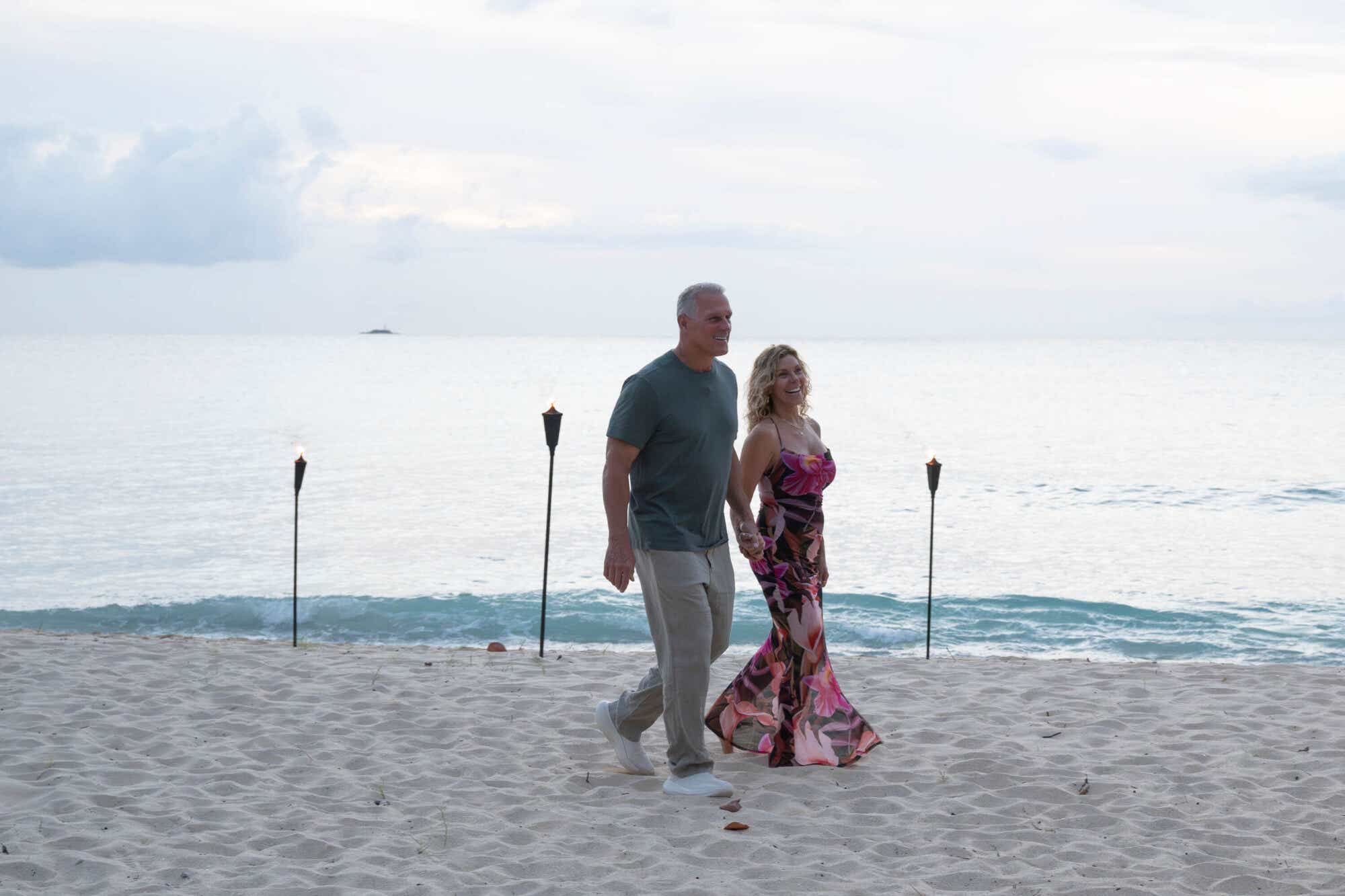 Mel Owens and Peg walk along the beach