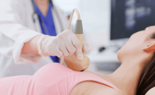 A doctor performing a breast ultrasound