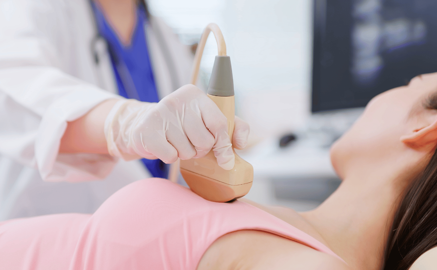 A doctor performing a breast ultrasound
