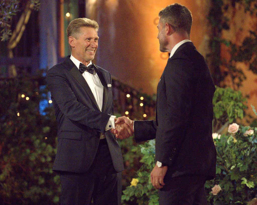Gerry Turner shakes hands with Jesse Palmer outside the Bachelor mansion on night one of The Golden Bachelor