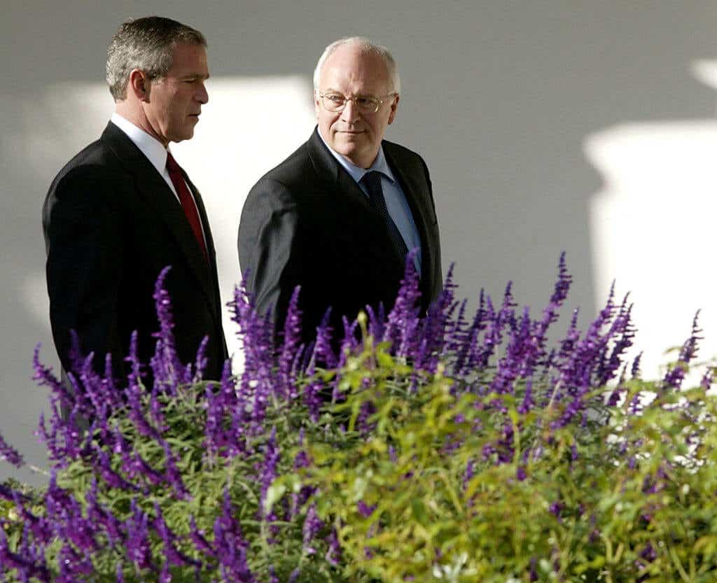 George W. Bush and Dick Cheney walking outside the White House