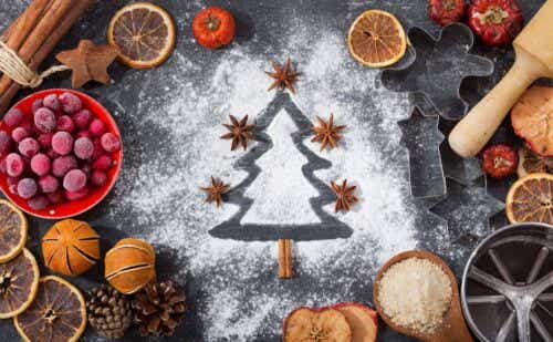 A Christmas tree outline traced in powdered sugar, surrounded by baking tools and accessories.