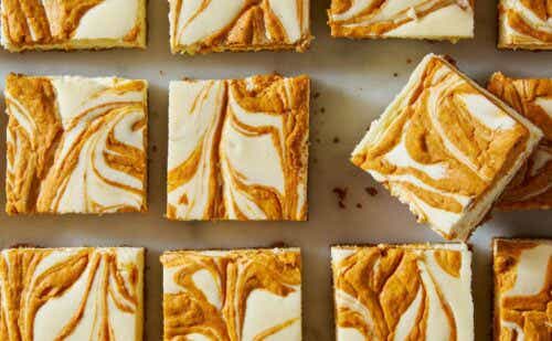 Delish Pumpkin Cheesecake Bars with creamy pumpkin swirl on graham cracker crust.