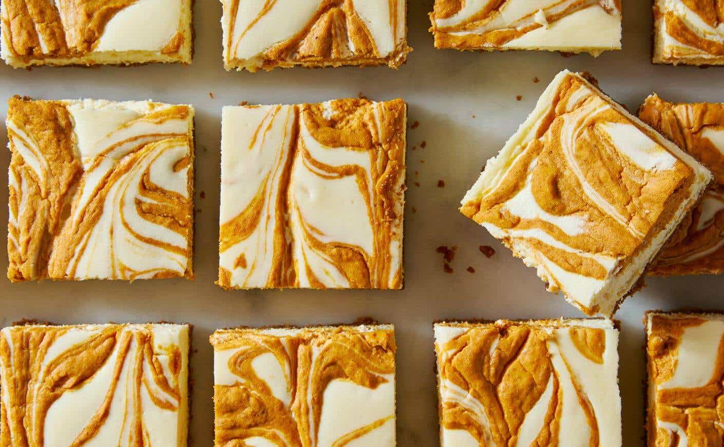 Delish Pumpkin Cheesecake Bars with creamy pumpkin swirl on graham cracker crust.