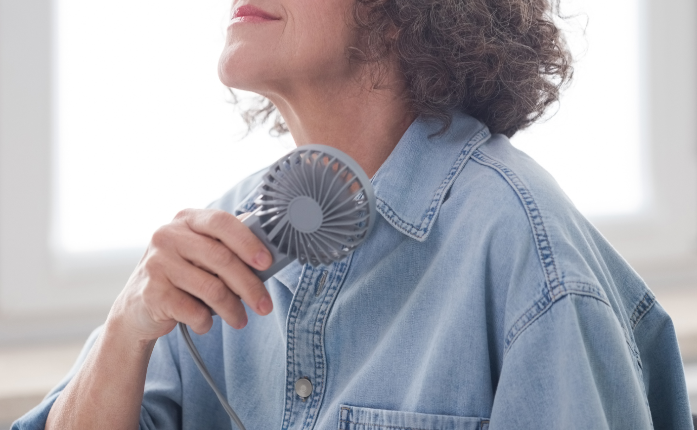 a woman holding a fan