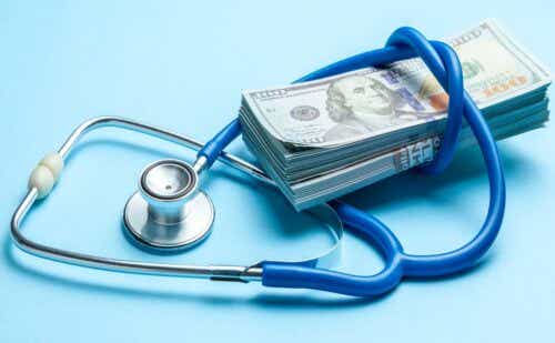 stethoscope wrapped around a stack of cash