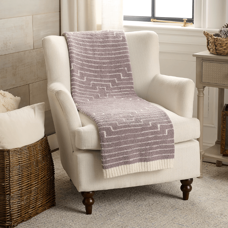 Barefoot dreams blanket on chair