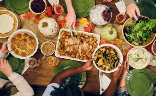 people gathered around a table eating thanksgiving dinner