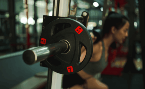 woman lifting weights in gym