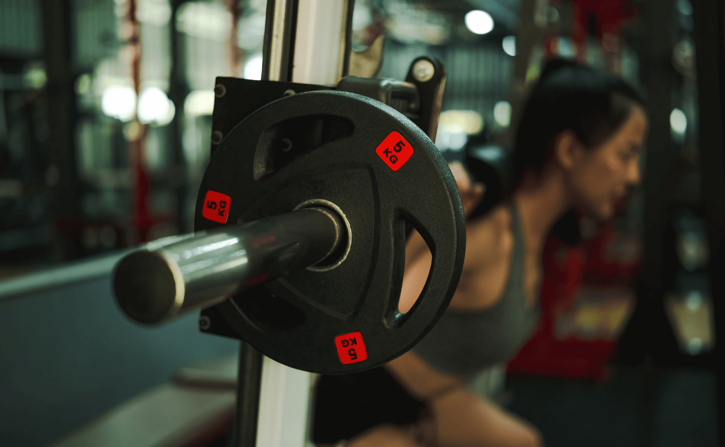 woman lifting weights in gym
