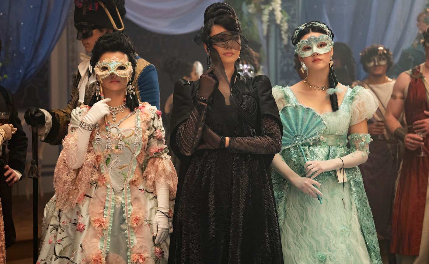 three female bridgerton characters in ball gowns wearing masquerade masks