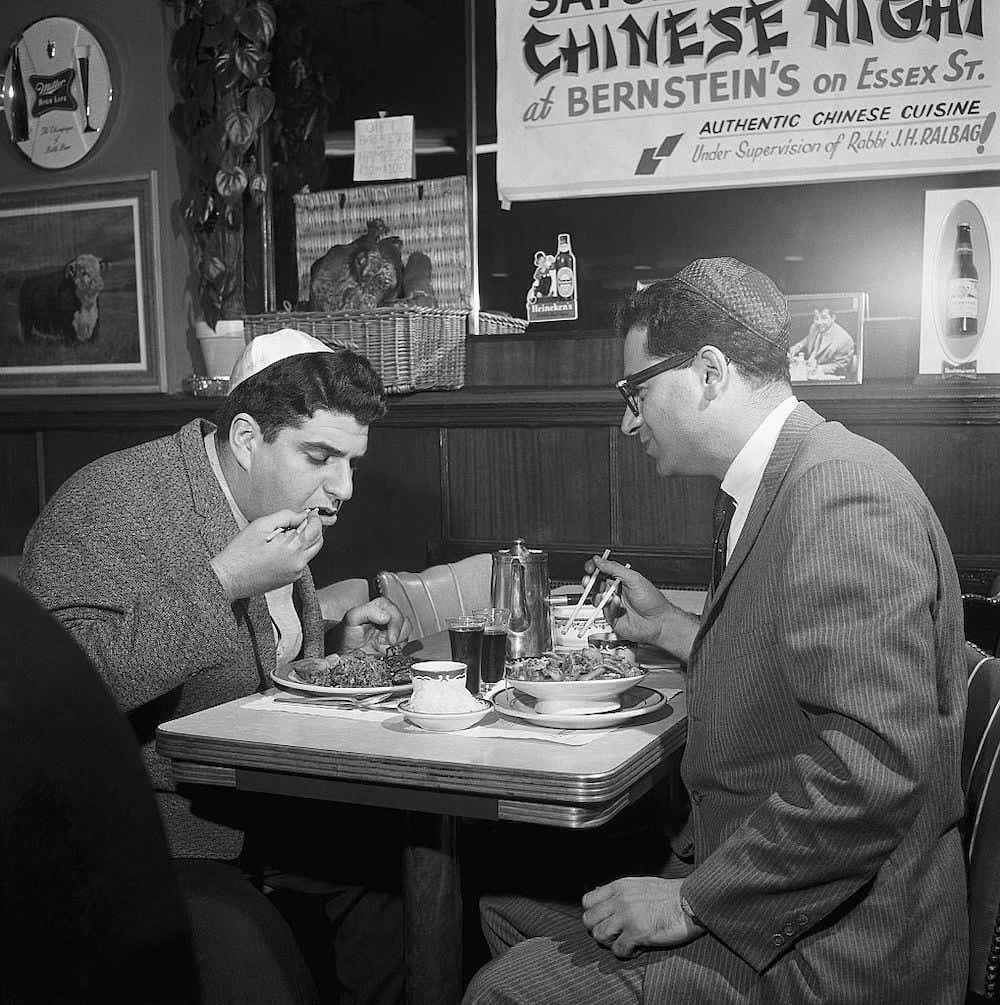 Two Jewish men eating at a Chinese restaurant.