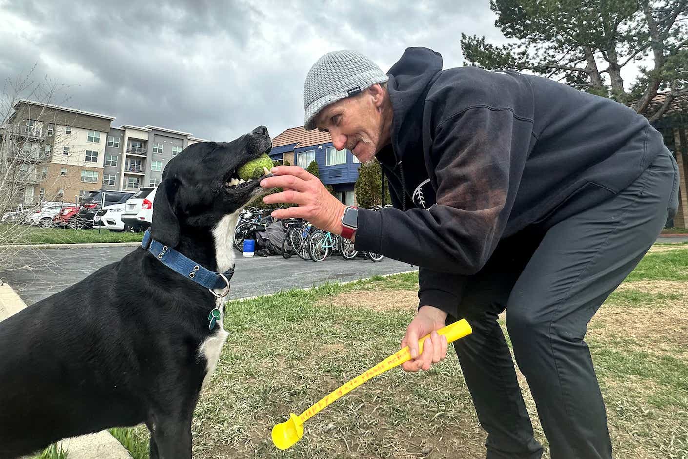 Jeff Gregg plays fetch with his dog, Ruffy, outside the MVP Shelter in Sandy, Utah. He says the specialized medical services helped him stop using opioids and get surgery for chronic back pain. He hopes that will allow him to get a job and afford an apartment. (Aaron Bolton/Montana Public Radio)