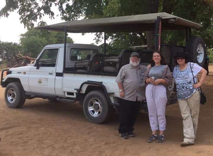 Randy Webster, his wife Karon and daughter Janet pose in front of truck on a family trip to Botswana