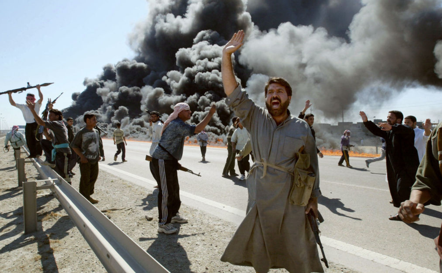 Iraqi Sunni Muslim insurgents celebrate in front of a burning U.S. convoy they attacked earlier on April 8, 2004, on the outskirts of the flashpoint town of Fallujah. Karim Sahib, AFP/Getty Images