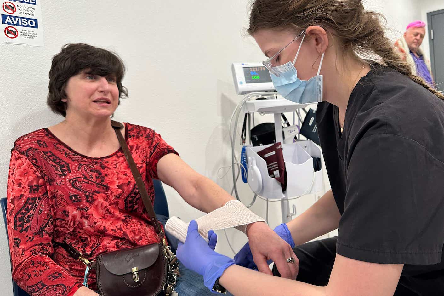 On-site emergency medical technician Emily Woolsey wraps the swollen wrist of MVP shelter resident Jamie Mangum after a fall. Mangum says that in other shelters, she’d likely have had to find her own way to an urgent care office to get treatment. She credits the shelter for helping her deal with all her medical issues. (Aaron Bolton/Montana Public Radio)
