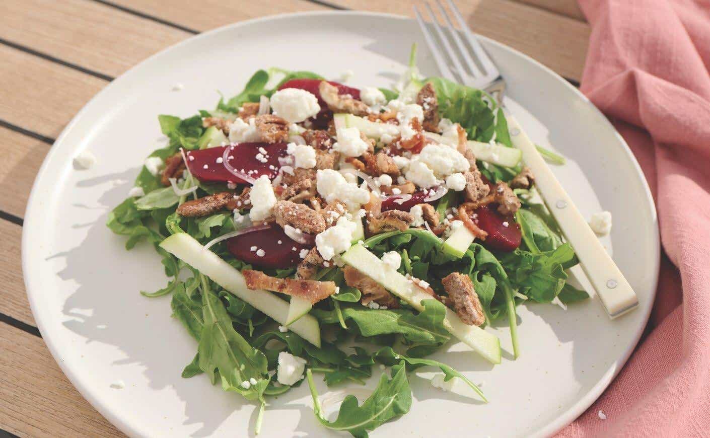 A beet and goat cheese salad on a plate.