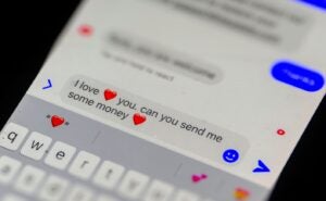 a phone showing a text message that says "i love you, can you send me money"