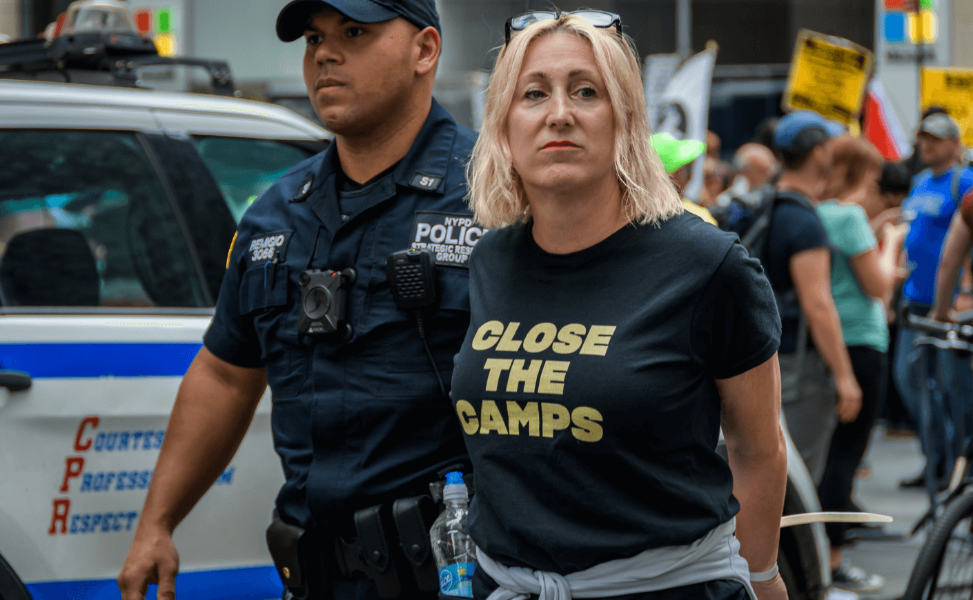 woman being arrested at ice protest