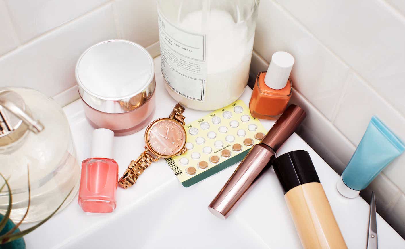Overhead view of beauty products on bathroom sink