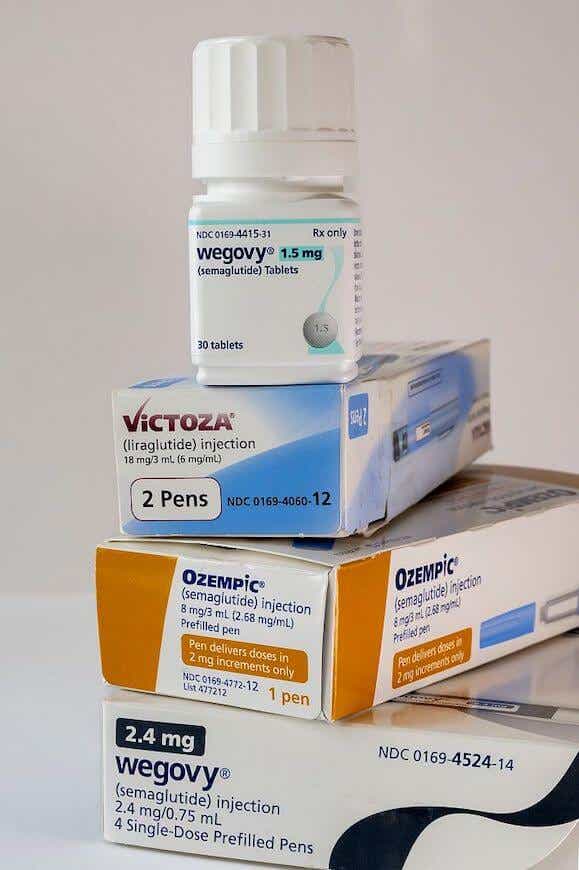 A vertical stack of assorted GLP-1 medications.