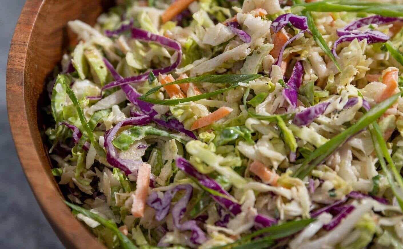 A wooden bowl of coleslaw.