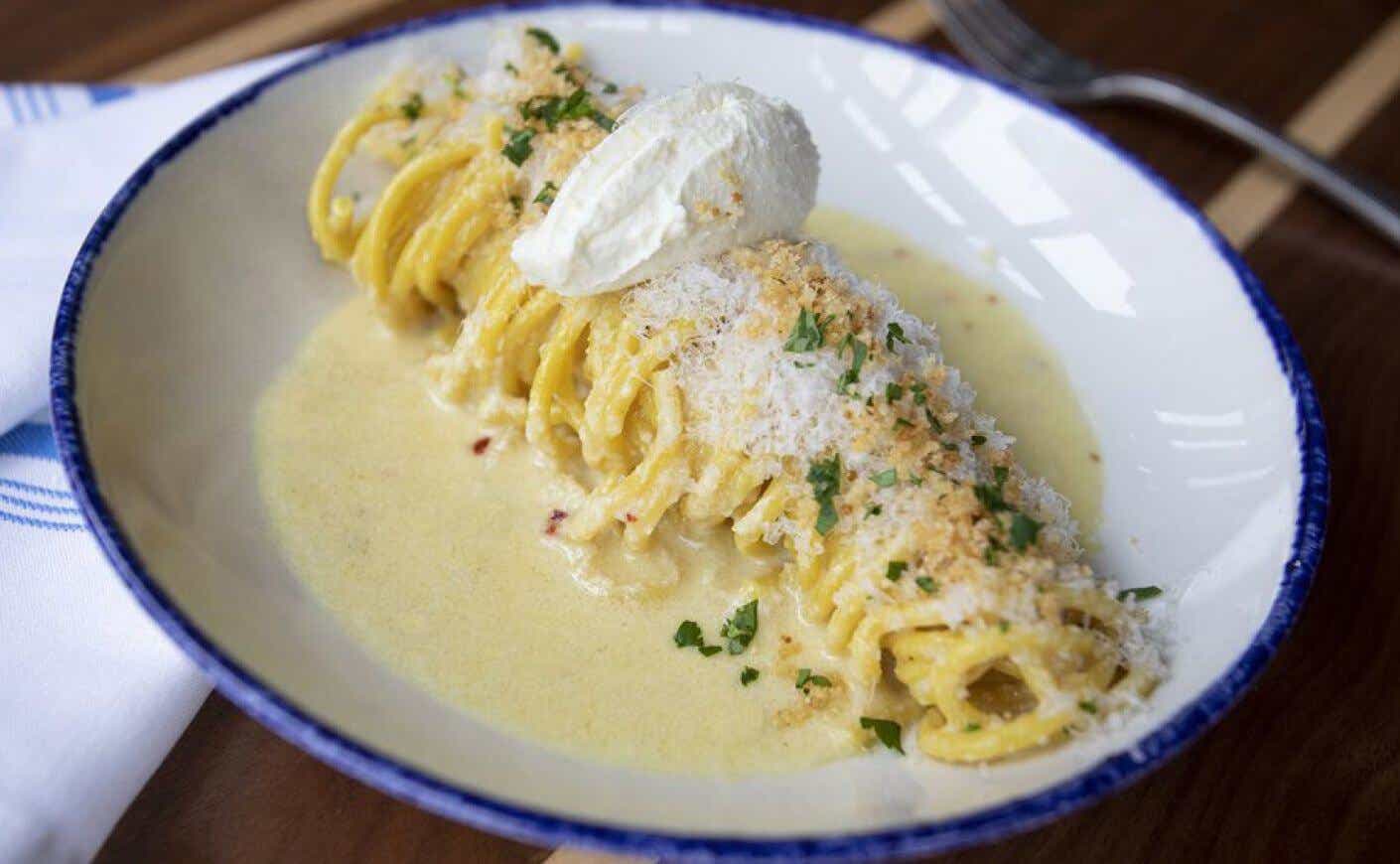 A plate of handmade spaghetti, Meyer lemon, chili flakes, Parmigiano-Reggiano, garlic breadcrumbs, and ricotta cheese.