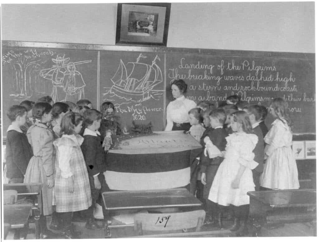 Students and their teacher in 1899, in a public school classroom. 