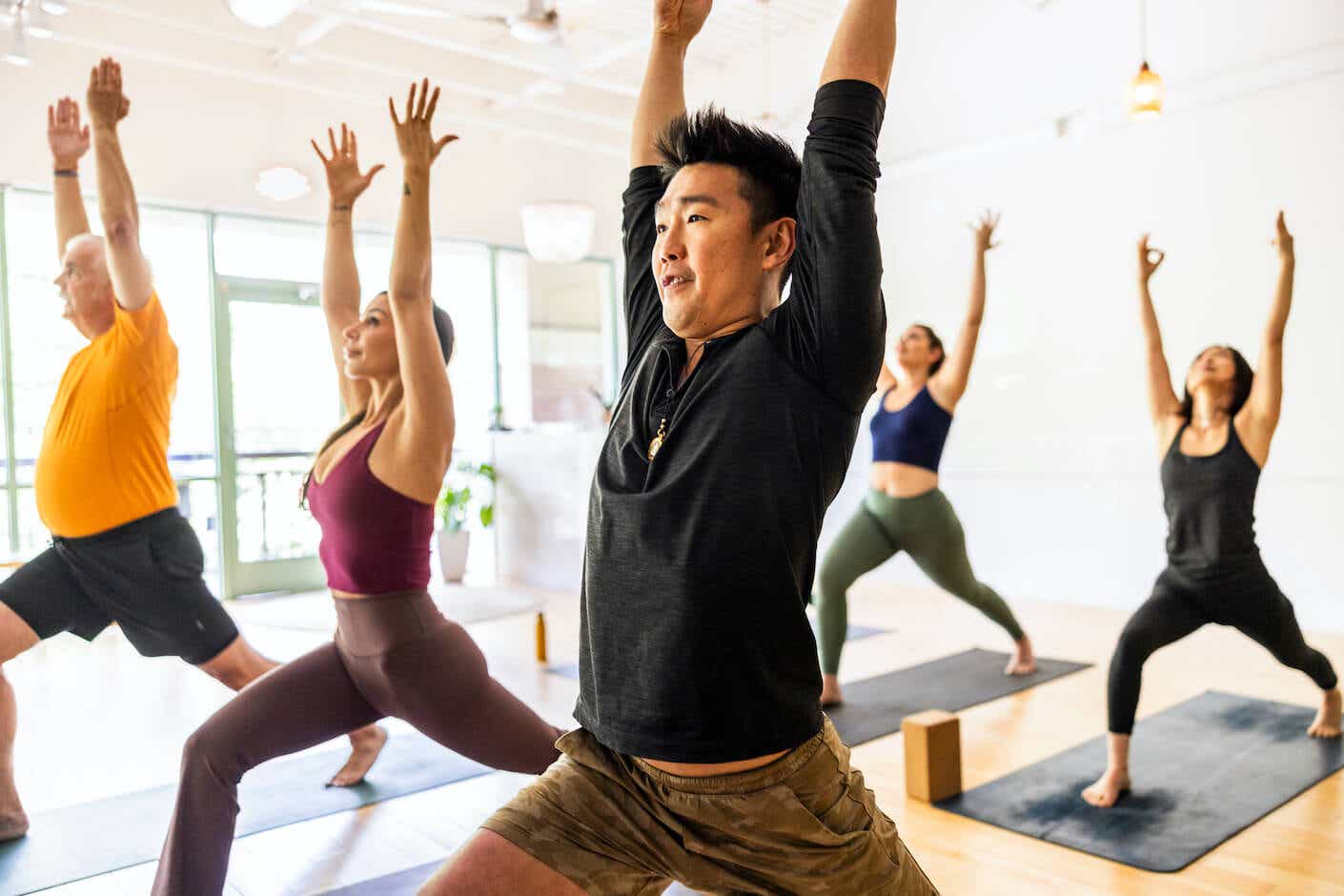 A group of people doing yoga in a class setting.
