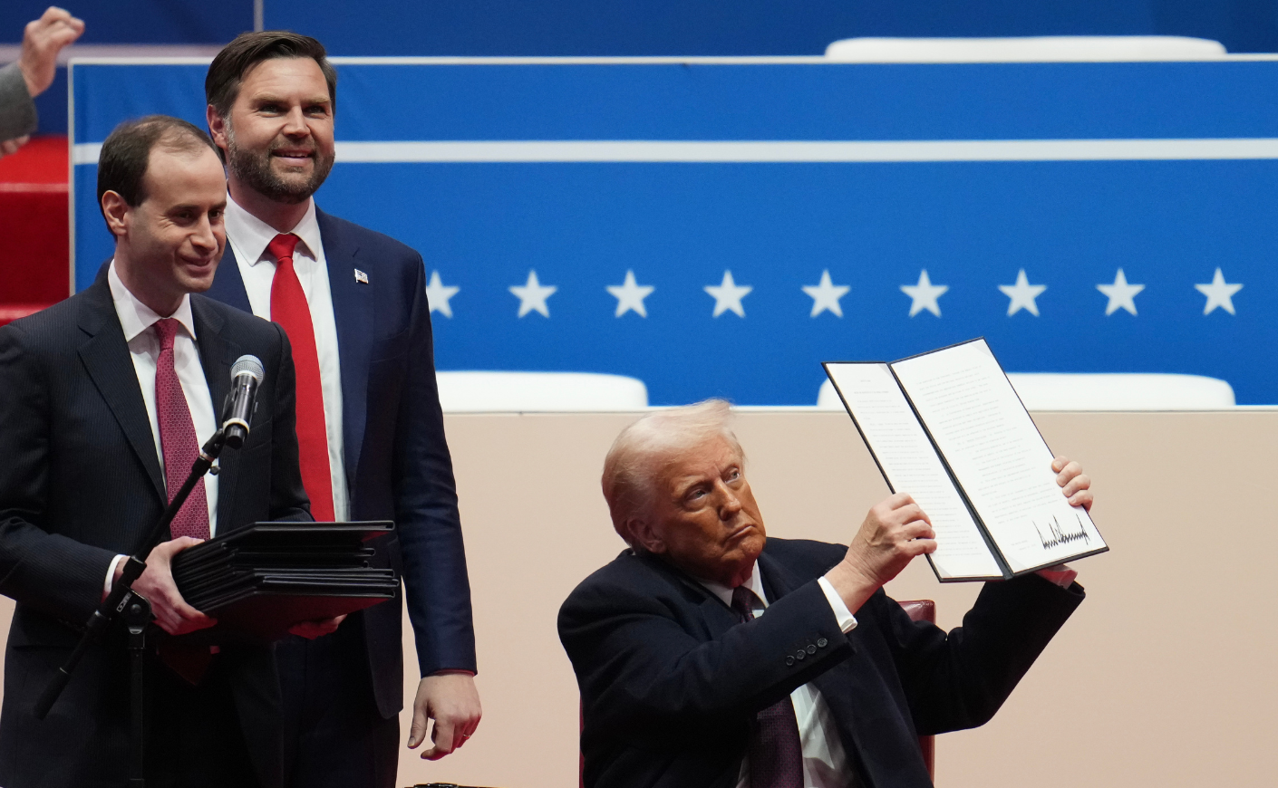President Trump signs an executive order shortly after his inauguration on Jan. 20, 2025. JD Vance stands behind him.