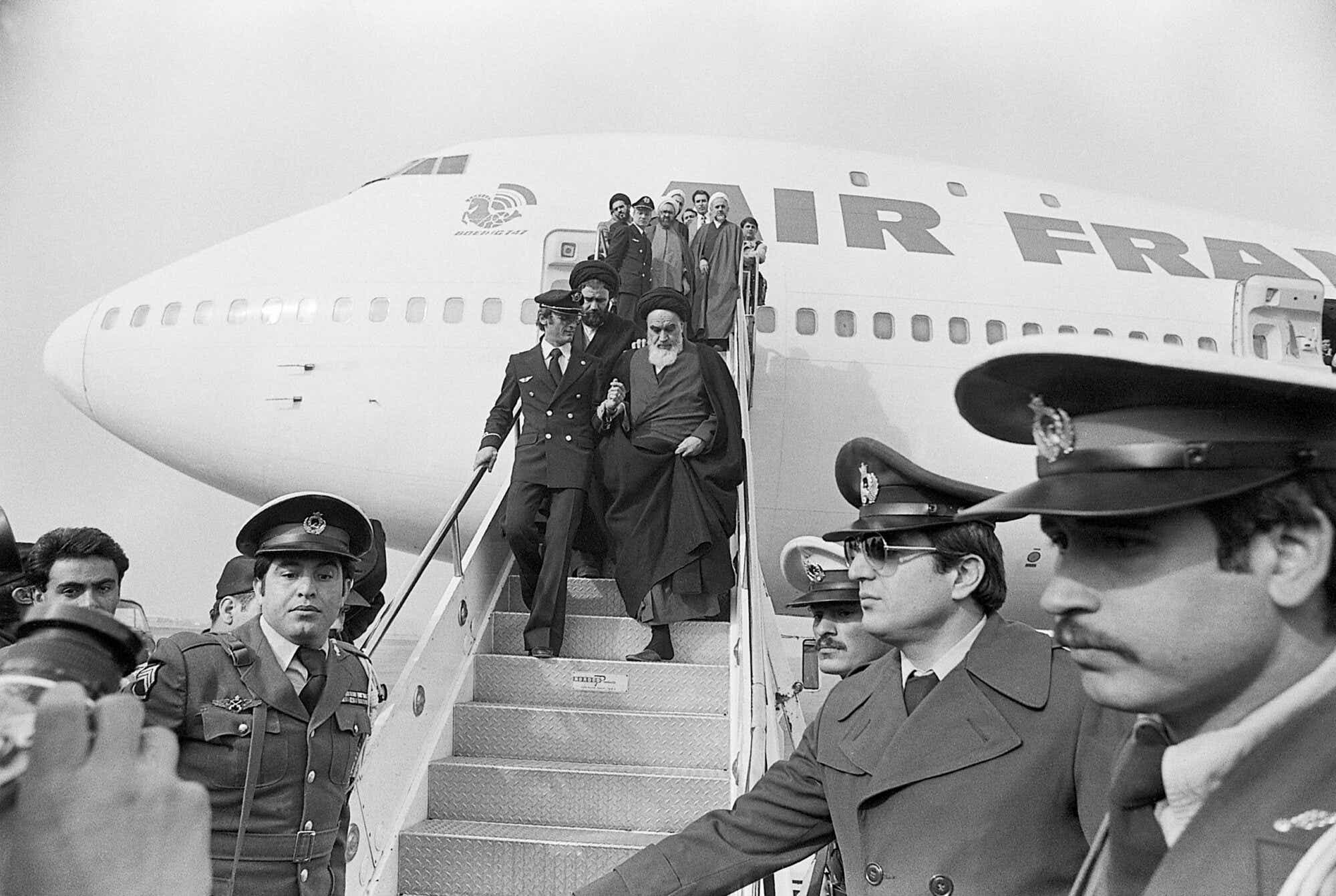Ayatollah Ruhollah Khomeini, Iran's main opposition leader, is shown stepping down the Air France plane which brought him to Tehran from 15 years of exile.