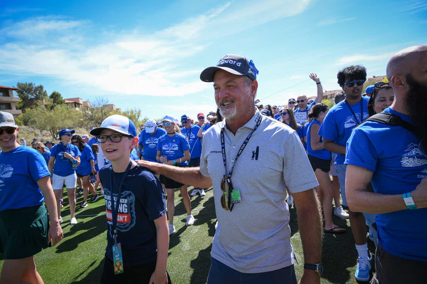 Jerry Kelly surrounded by people wearing blue 