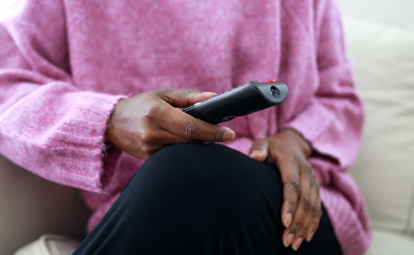 black woman holding a remote
