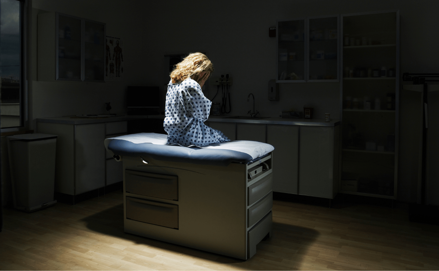 woman sitting in doctor's exam room