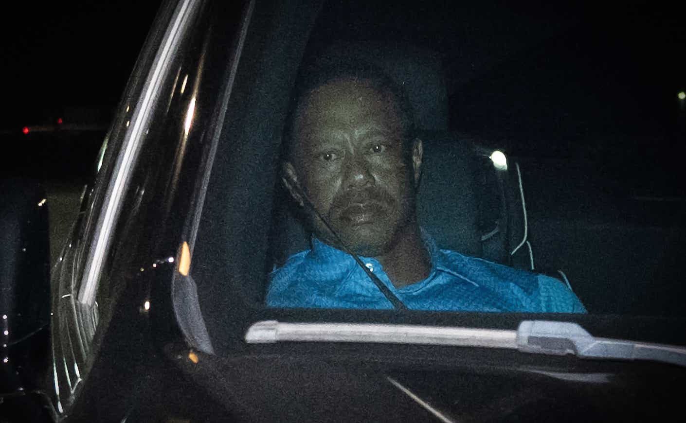 tiger woods looking out a window from a car