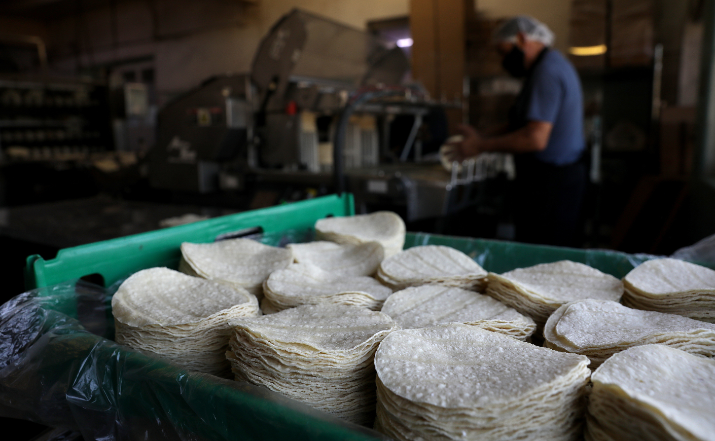 Corn tortillas are stacked inside of La Gloria Mexican Foods, one of the oldest tortilla factories in the city