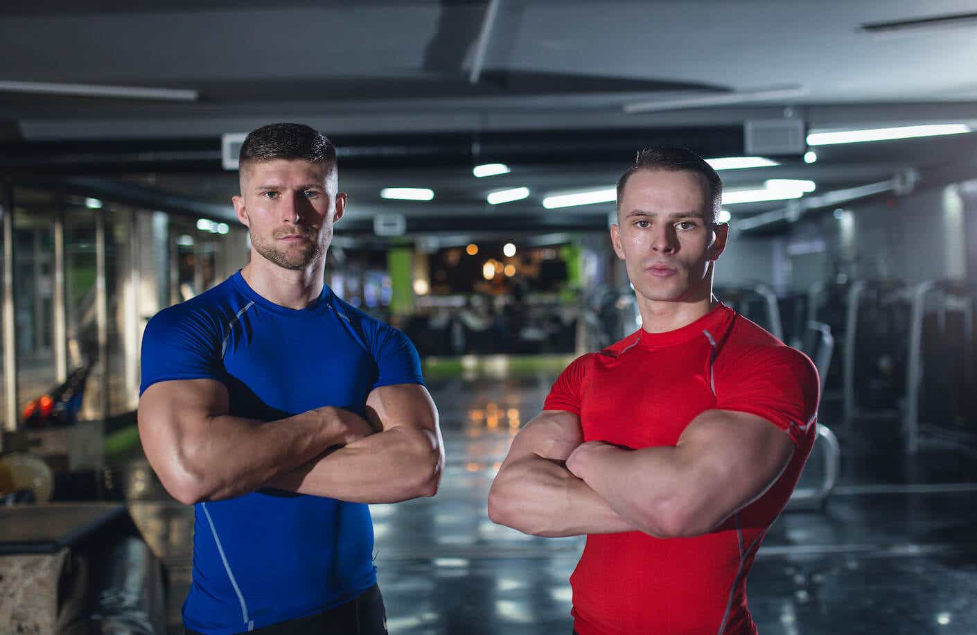Two young men standing in a gym.