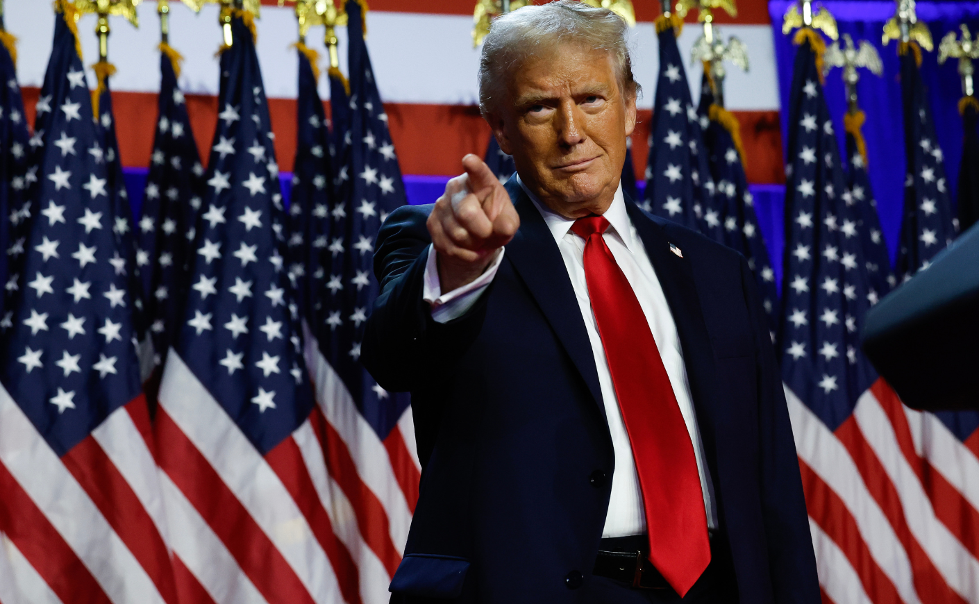 Donald Trump pointing on a stage