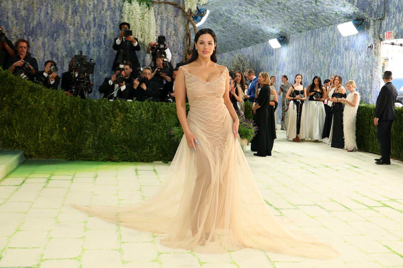 ashley graham posing on the met gala 2026 red carpet in a nude gown