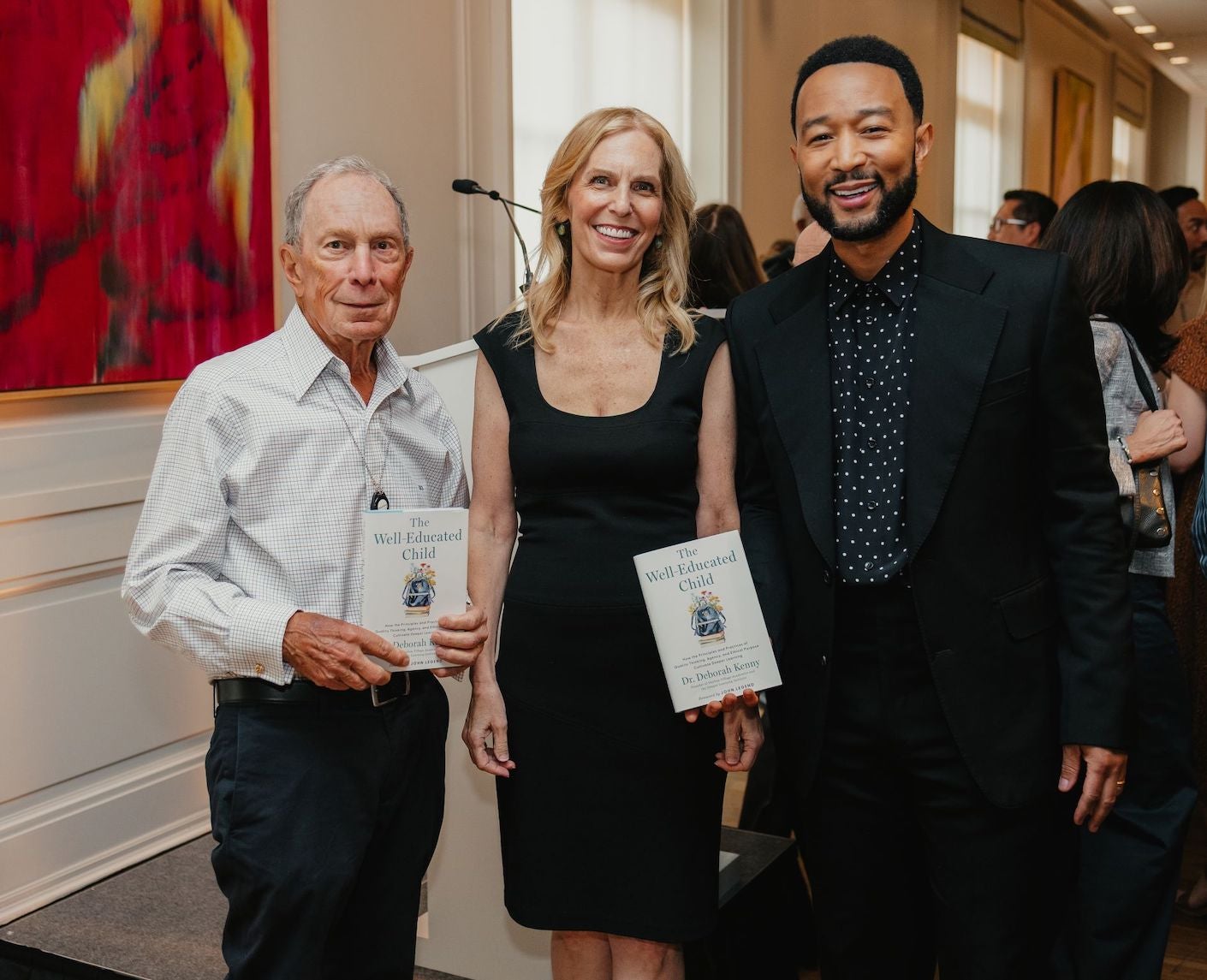 Mike Bloomberg + John Legend with Deborah Kenny holding her book 'The Well-Educated Child'
