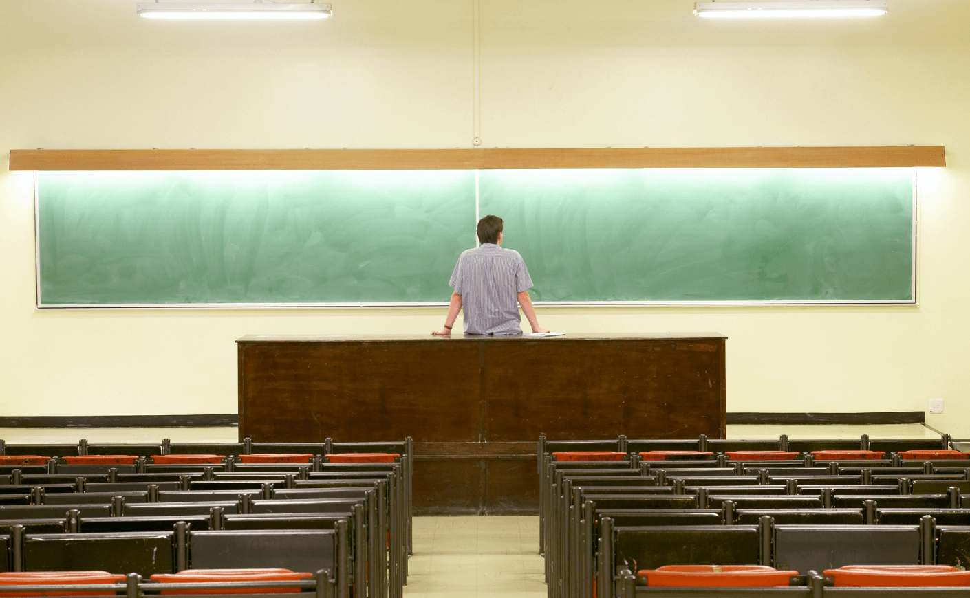 college professor in empty classroom