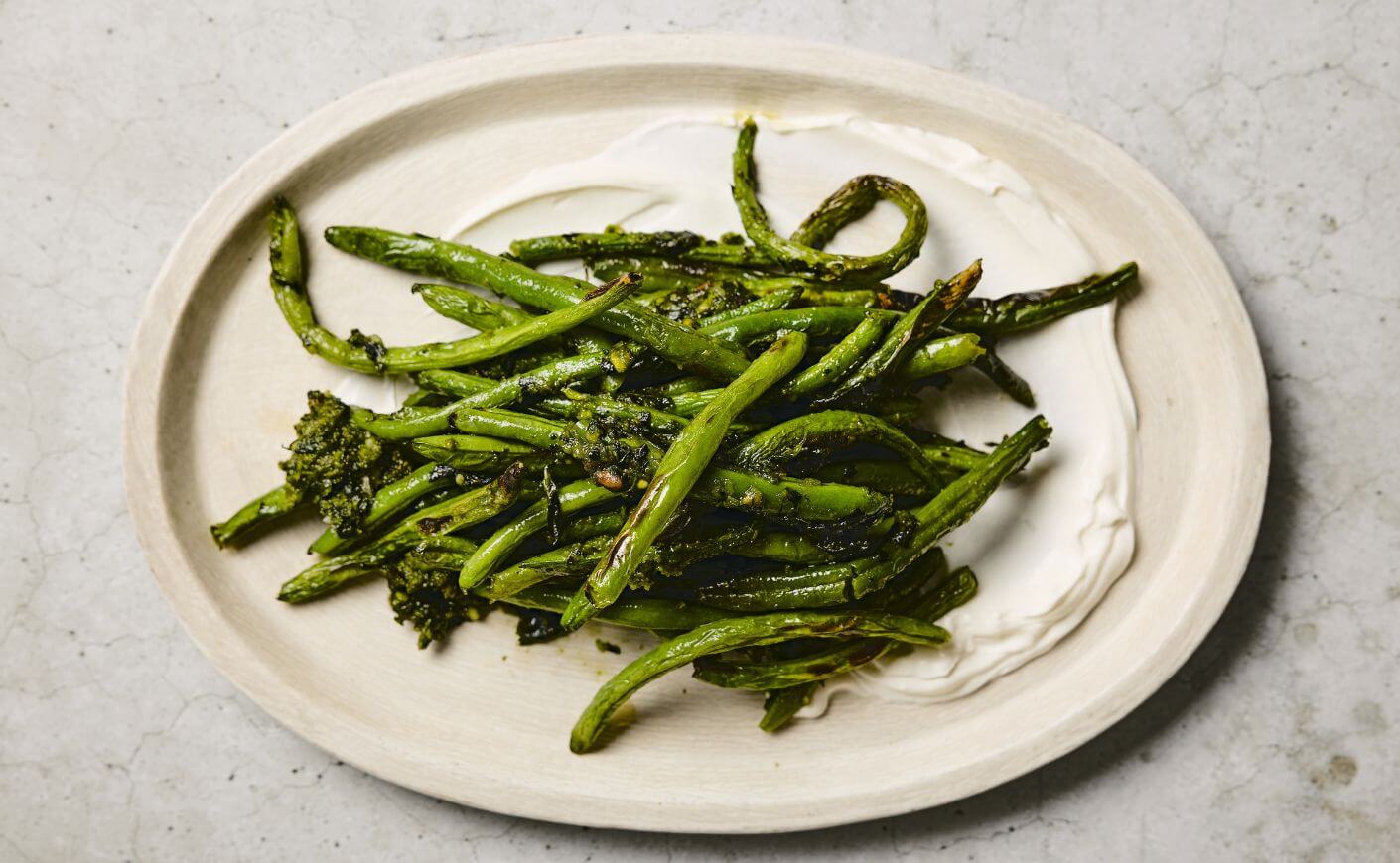 A plate of green beans with basil-pistachio sauce.