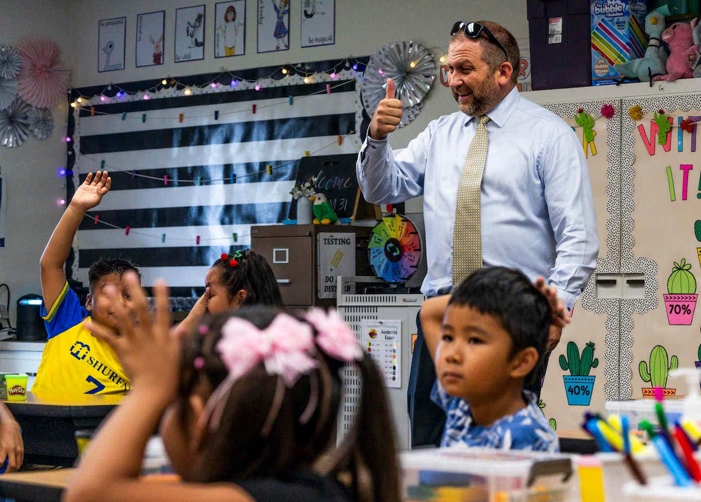 Principal Chris Ash greets students during the first day of class at Eisenhower Elementary School in Garden Grove, CA.