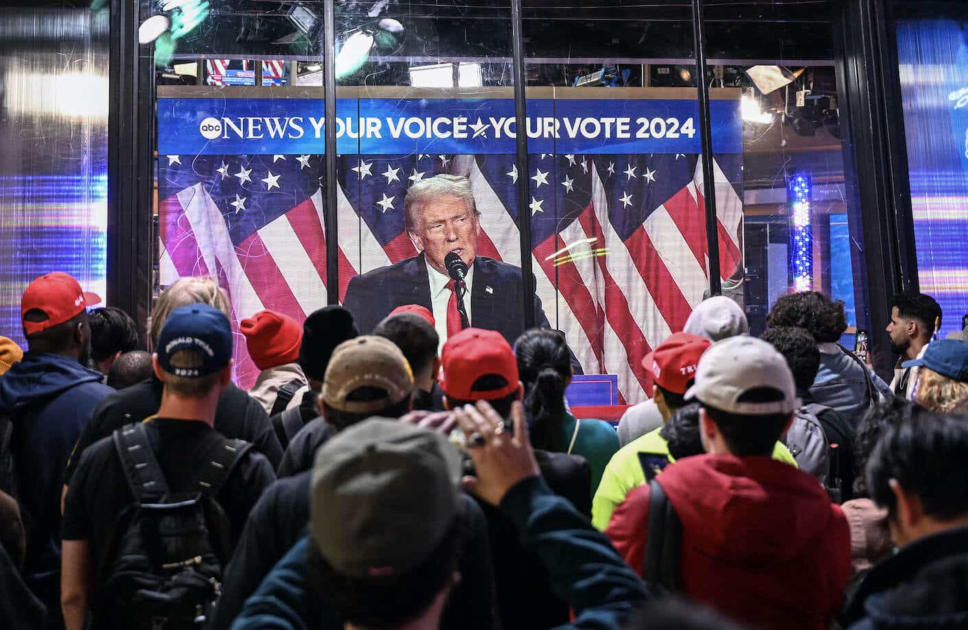 New York City residents watch Donald Trump speak.
