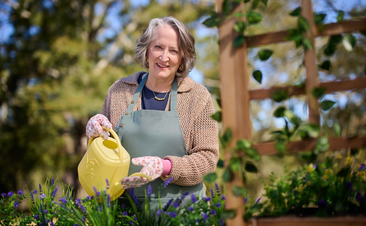 Patient Shawna in her garden watering plants